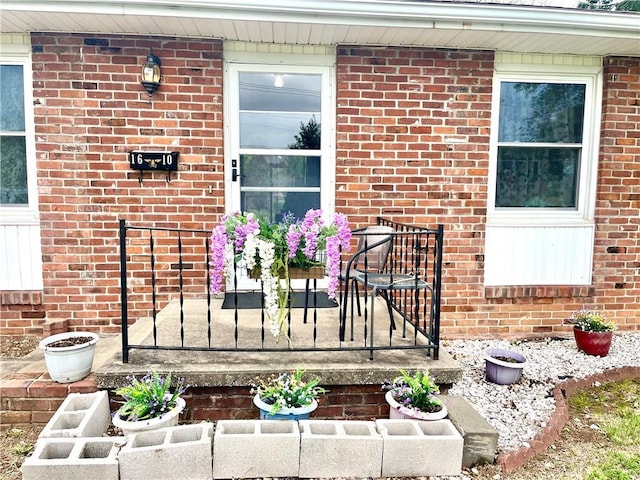 property entrance featuring brick siding