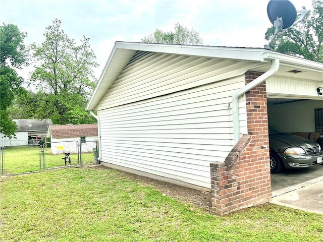 view of home's exterior with a lawn, a gate, a garage, and fence