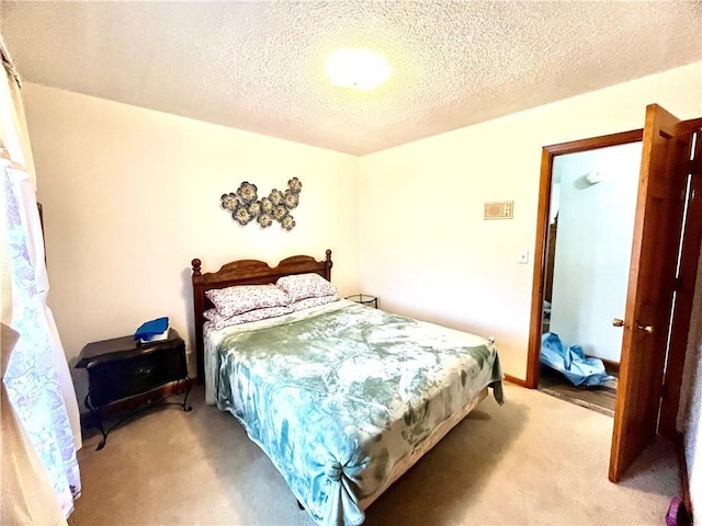 bedroom featuring a textured ceiling and light colored carpet