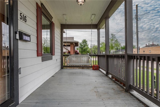 516 Parker St, Osawatomie, KS 66064 - deck featuring covered porch
