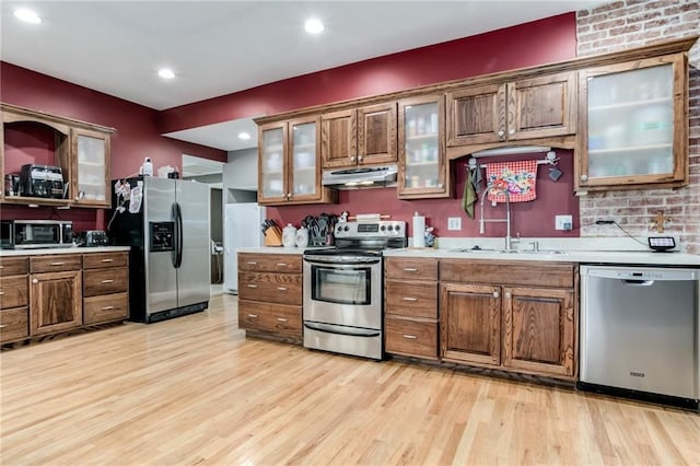 516 Parker St, Osawatomie, KS 66064 - kitchen with stainless steel appliances, extractor fan, a sink, light countertops, and recessed lighting