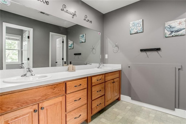 516 Parker St, Osawatomie, KS 66064 - bathroom featuring baseboards and double vanity