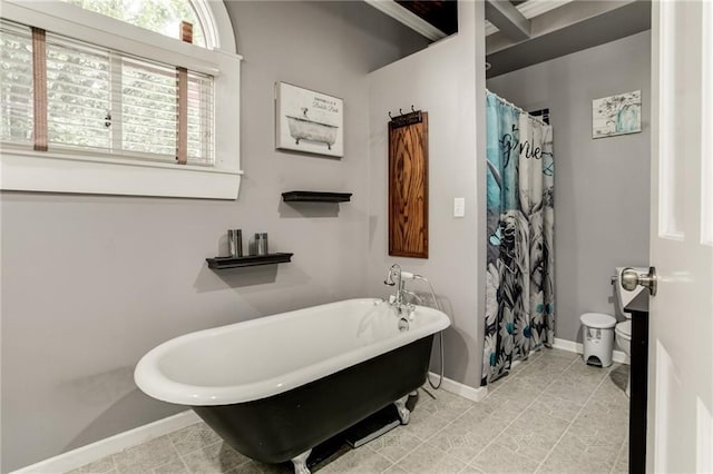 516 Parker St, Osawatomie, KS 66064 - bathroom with baseboards and a freestanding bath