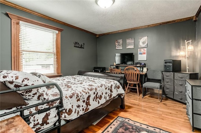 516 Parker St, Osawatomie, KS 66064 - bedroom with ornamental molding, wood finished floors, and a textured ceiling