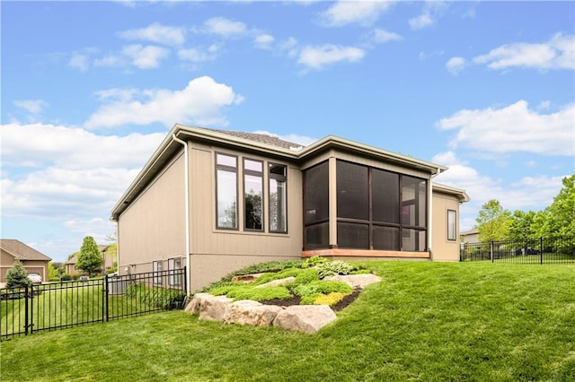 rear view of property with a sunroom