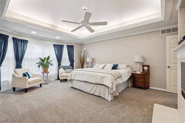 bedroom with visible vents, carpet flooring, ornamental molding, a tray ceiling, and recessed lighting