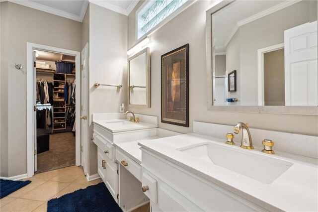 bathroom featuring a sink, ornamental molding, double vanity, and a spacious closet