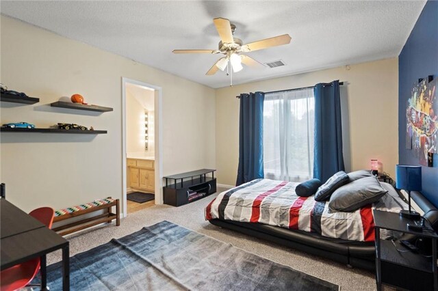 bedroom featuring visible vents, carpet floors, ceiling fan, a textured ceiling, and ensuite bath