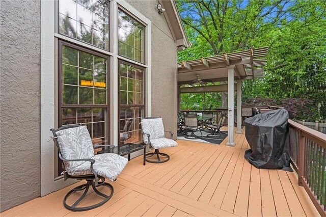 deck featuring ceiling fan, grilling area, and outdoor dining space