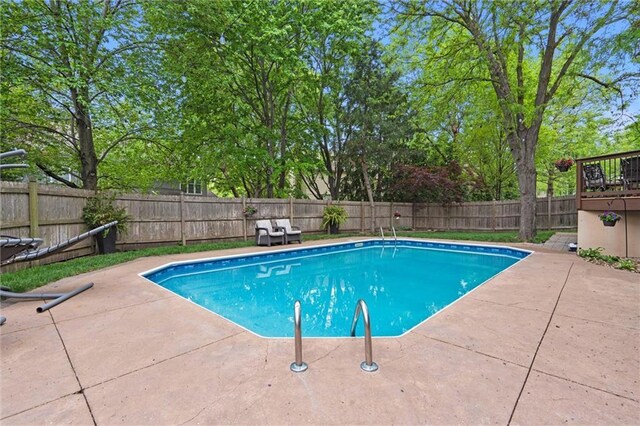 view of swimming pool featuring a fenced backyard, a fenced in pool, and a patio