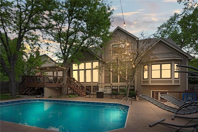 rear view of house featuring an outdoor pool, a patio area, stairway, and a deck