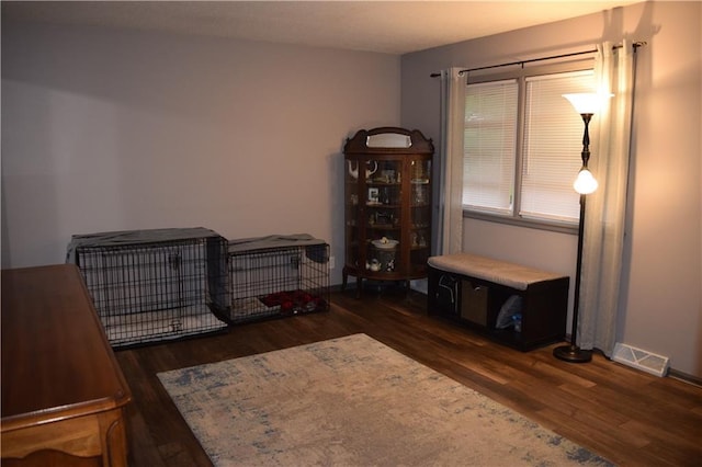 interior space with visible vents, wood finished floors, and baseboards