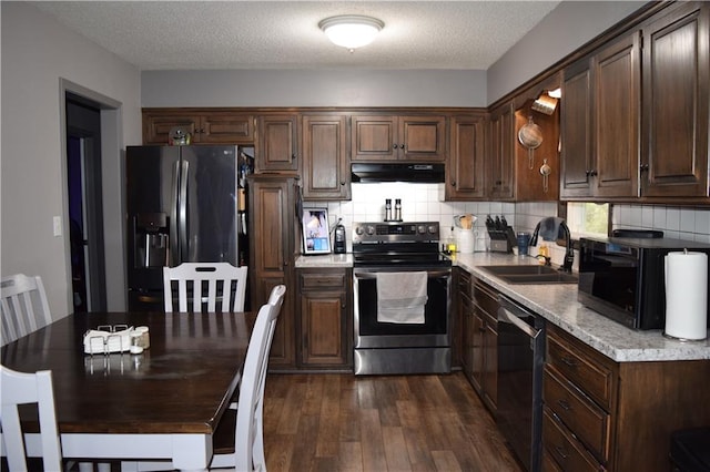 kitchen featuring dark wood-style floors, a sink, stainless steel appliances, ventilation hood, and light countertops