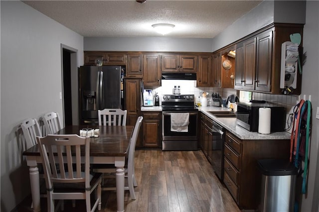 kitchen featuring electric range, extractor fan, black refrigerator with ice dispenser, a sink, and dishwashing machine