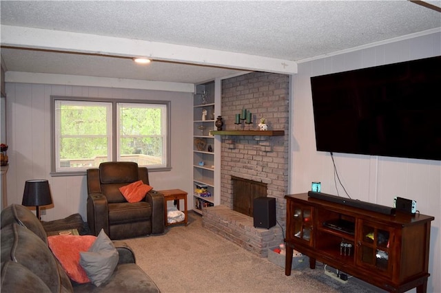 living room with carpet flooring, a fireplace, built in shelves, ornamental molding, and a textured ceiling
