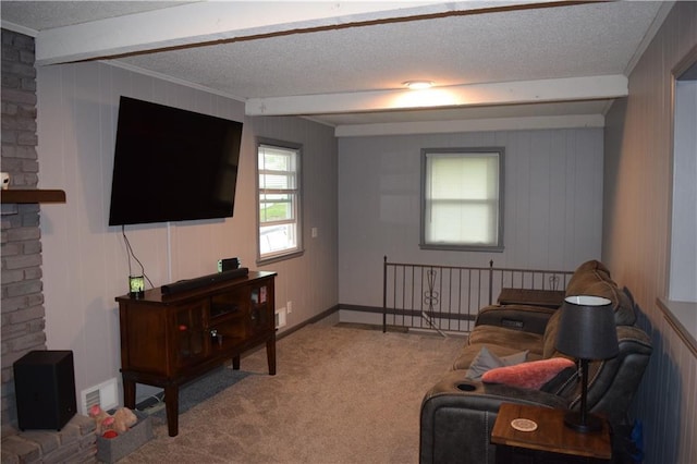 carpeted living room with ornamental molding, a textured ceiling, and beamed ceiling