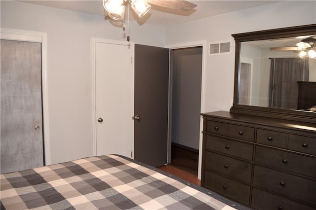 unfurnished bedroom featuring visible vents, a ceiling fan, and light wood-style flooring