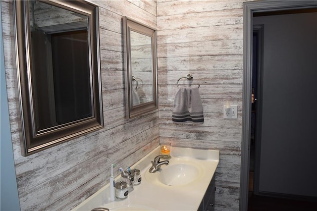 bathroom with wooden walls and vanity