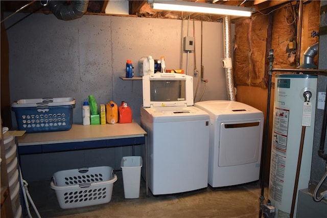 laundry area featuring gas water heater, washer and dryer, and laundry area