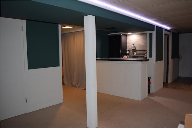 finished below grade area featuring light colored carpet