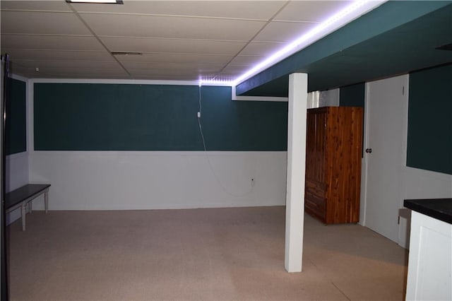 finished below grade area with carpet and a drop ceiling