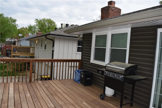 wooden deck featuring area for grilling