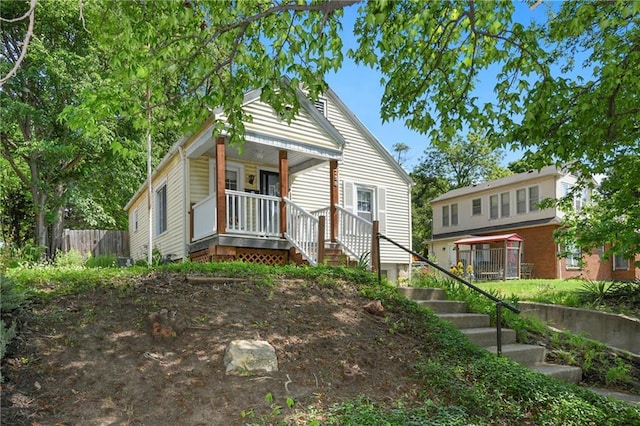 758 Pennsylvania St, Leavenworth, KS 66048 - shotgun-style home featuring a porch and stairway