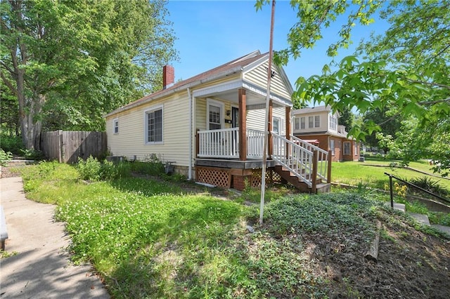 758 Pennsylvania St, Leavenworth, KS 66048 - view of front of property with a porch and a chimney