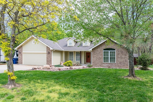 traditional home featuring brick siding, an attached garage, driveway, and a front yard