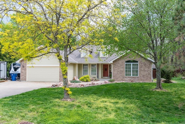 view of front of property featuring roof with shingles, an attached garage, brick siding, a front yard, and driveway