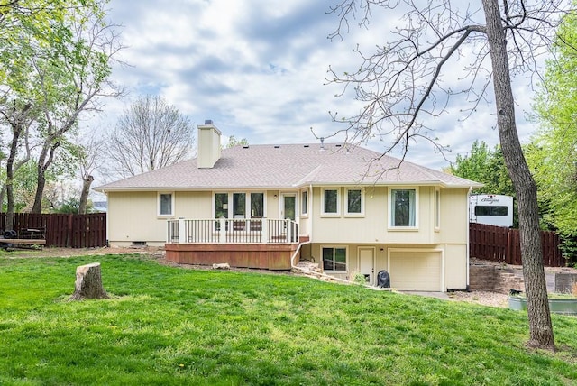 back of house with a chimney, a lawn, a deck, a garage, and fence