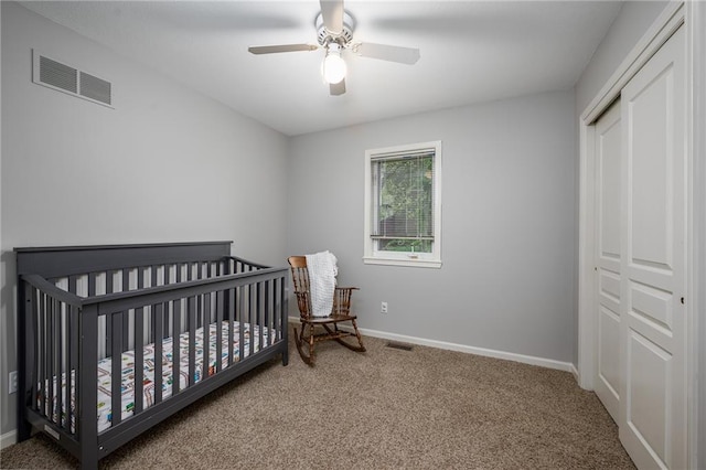 bedroom with carpet floors, baseboards, visible vents, and a closet