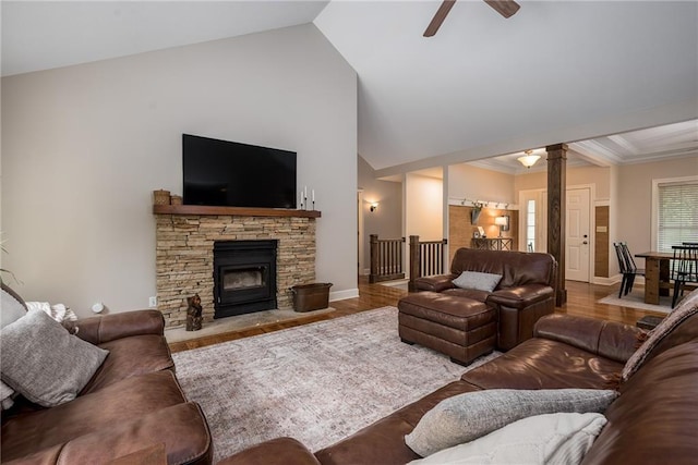 living room featuring baseboards, decorative columns, a ceiling fan, and wood finished floors