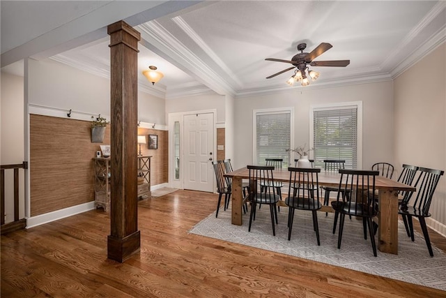 dining room featuring ornate columns, a ceiling fan, baseboards, and wood finished floors
