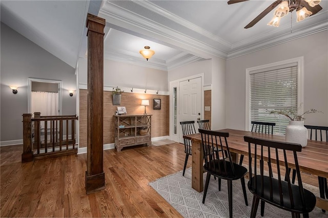 dining space with baseboards, ceiling fan, wood finished floors, and ornate columns