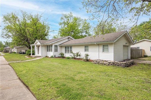 306 S 5th St, Neodesha, KS 66757 - view of front of property with fence, a garage, driveway, roof with shingles, and a front yard