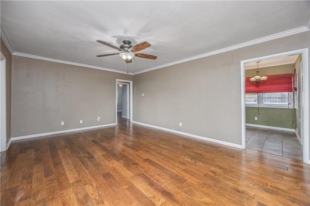 306 S 5th St, Neodesha, KS 66757 - empty room featuring wood finished floors, baseboards, ornamental molding, and ceiling fan with notable chandelier