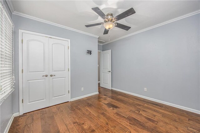 306 S 5th St, Neodesha, KS 66757 - unfurnished bedroom featuring baseboards, wood finished floors, a closet, and crown molding