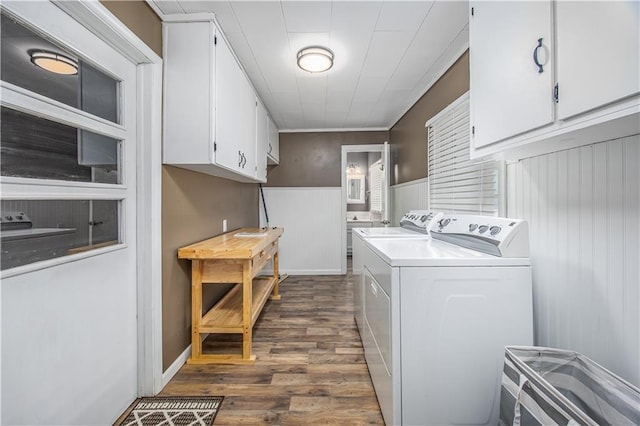 306 S 5th St, Neodesha, KS 66757 - laundry room with dark wood-style flooring, cabinet space, wainscoting, and washing machine and dryer