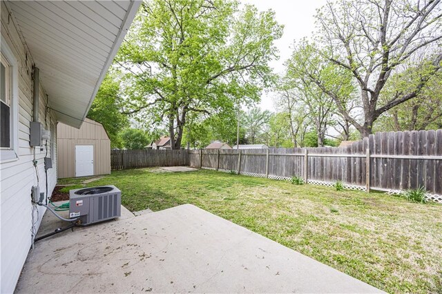 306 S 5th St, Neodesha, KS 66757 - view of yard with a patio area, central AC unit, a shed, and a fenced backyard