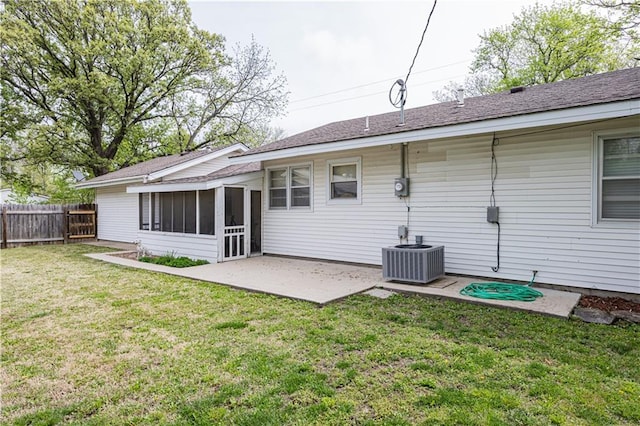 306 S 5th St, Neodesha, KS 66757 - back of house featuring a sunroom, central air condition unit, a patio area, a yard, and fence