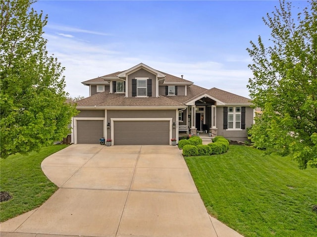 craftsman-style home featuring driveway, a front lawn, roof with shingles, and stucco siding