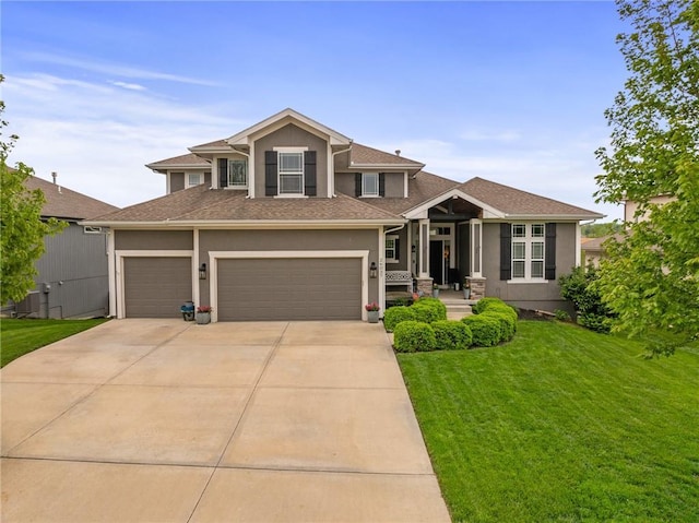 view of front facade with a front lawn, stucco siding, a shingled roof, an attached garage, and driveway