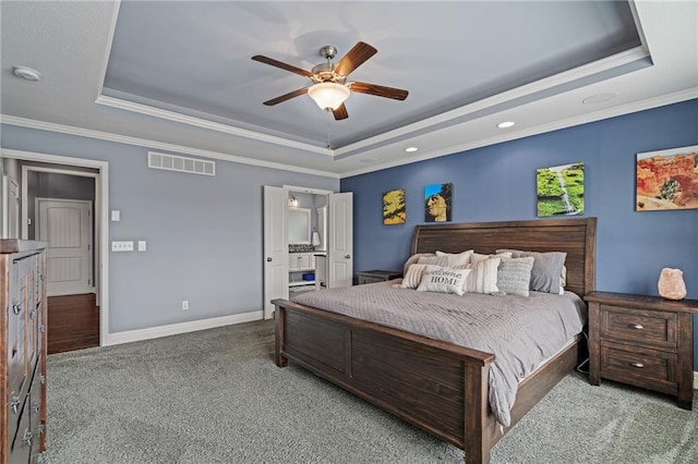 carpeted bedroom with ceiling fan, visible vents, a raised ceiling, baseboards, and ornamental molding