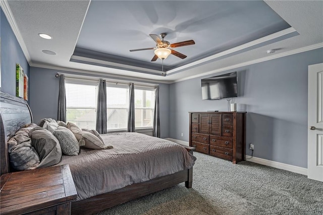 carpeted bedroom with baseboards, ornamental molding, and a raised ceiling