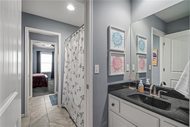 bathroom with a shower with shower curtain, marble finish floor, and vanity