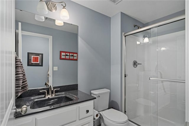 full bath with toilet, a shower stall, and vanity