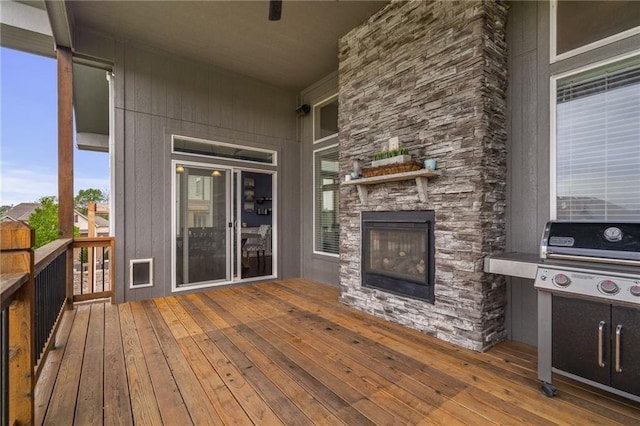 deck featuring an outdoor stone fireplace