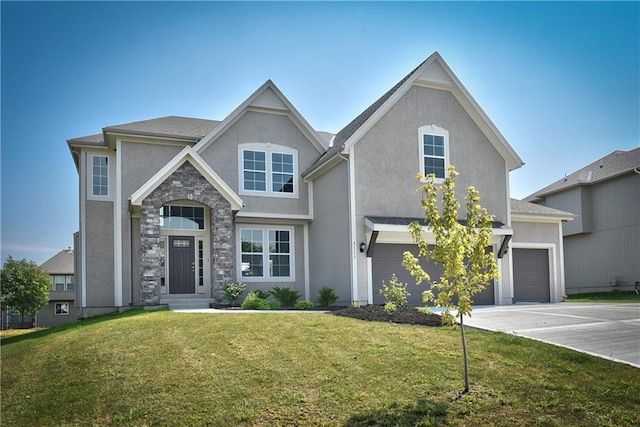 view of front of home with stucco siding, driveway, stone siding, and a front yard