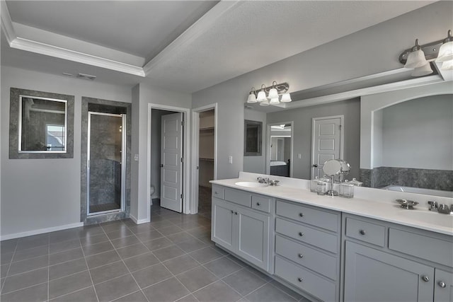 full bath with tile patterned flooring, double vanity, a sink, baseboards, and a stall shower